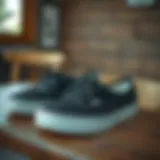 Stylish black Vans shoes on a wooden table